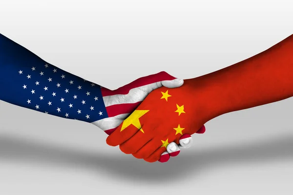 Handshake between china and united states of america flags painted on hands, illustration with clipping path.