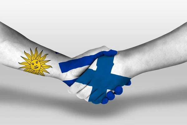 Рукопожатие Между Финскими Уругвайскими Флагами Раскрашенными Руках Иллюстрация Вырезкой — стоковое фото