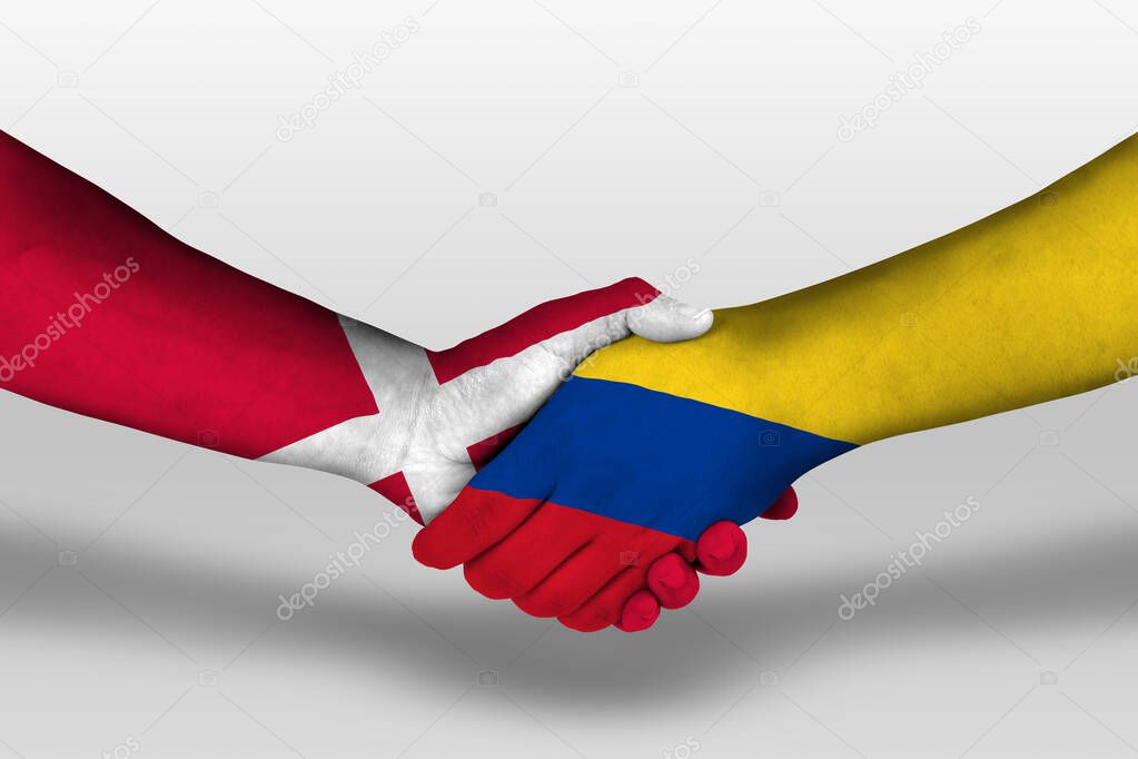 Handshake between columbia and denmark flags painted on hands, illustration with clipping path.