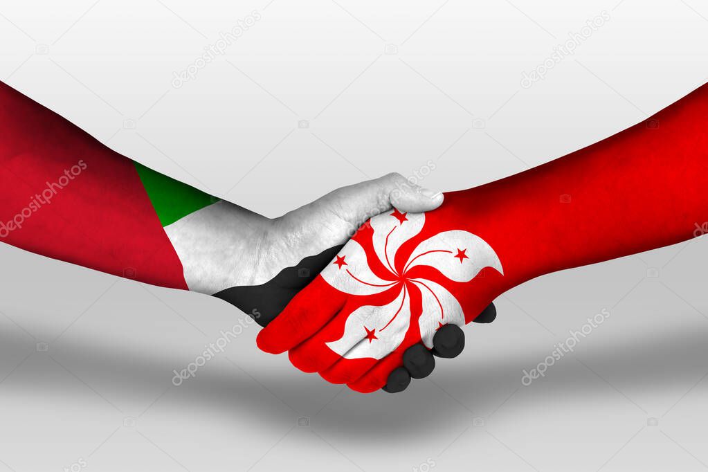 Handshake between hong kong and united arab emirates flags painted on hands, illustration with clipping path.