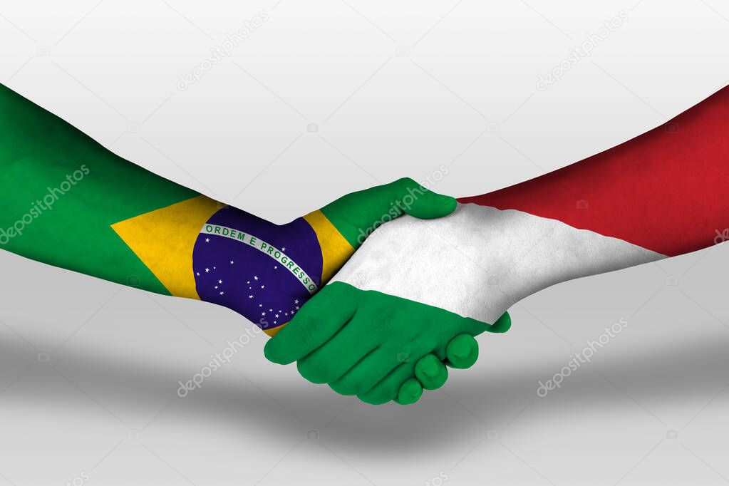 Handshake between hungary and brazil flags painted on hands, illustration with clipping path.