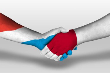 Handshake between japan and luxembourg flags painted on hands, illustration with clipping path.