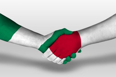 Handshake between japan and nigeria flags painted on hands, illustration with clipping path.