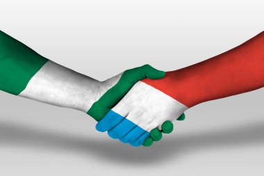Handshake between luxembourg and nigeria flags painted on hands, illustration with clipping path.