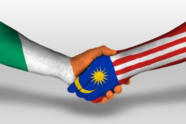 Handshake between malaysia and ireland flags painted on hands, illustration with clipping path.