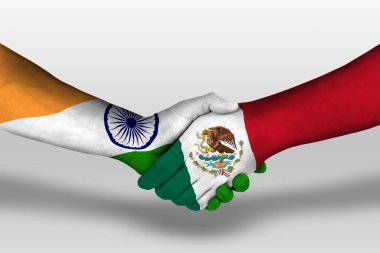 Handshake between mexico and india flags painted on hands, illustration with clipping path.