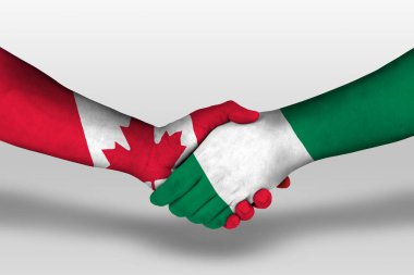 Handshake between nigeria and canada flags painted on hands, illustration with clipping path.