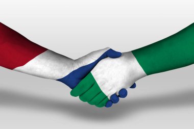 Handshake between nigeria and netherlands flags painted on hands, illustration with clipping path.
