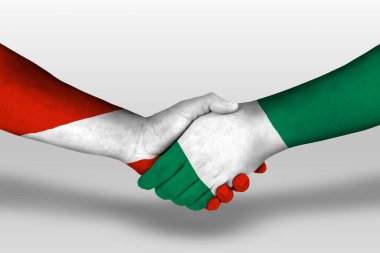 Handshake between nigeria and austria flags painted on hands, illustration with clipping path.
