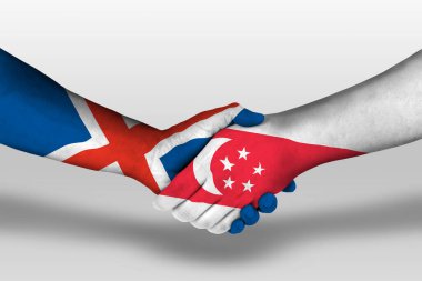 Handshake between singapore and iceland flags painted on hands, illustration with clipping path.