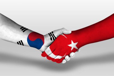 Handshake between turkey and south korea flags painted on hands, illustration with clipping path.