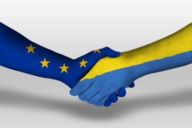 Handshake between ukraine and european union flags painted on hands, illustration with clipping path.