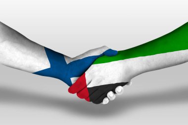 Handshake between united arab emirates and finland flags painted on hands, illustration with clipping path.
