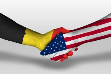 Handshake between united states of america and belgium flags painted on hands, illustration with clipping path.