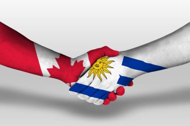 Handshake between uruguay and canada flags painted on hands, illustration with clipping path.