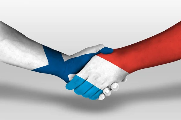 stock image Handshake between luxembourg and finland flags painted on hands, illustration with clipping path.