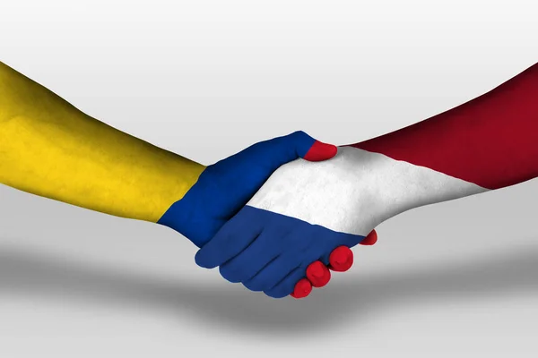 Χειραψία Μεταξύ Κάτω Χωρών Και Σημαίες Της Κολομβίας Ζωγραφισμένα Στα — Φωτογραφία Αρχείου