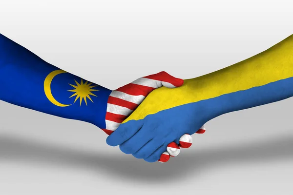 Рукопожатие Между Украинским Малайзийским Флагами Раскрашенными Руках Иллюстрация Вырезкой — стоковое фото