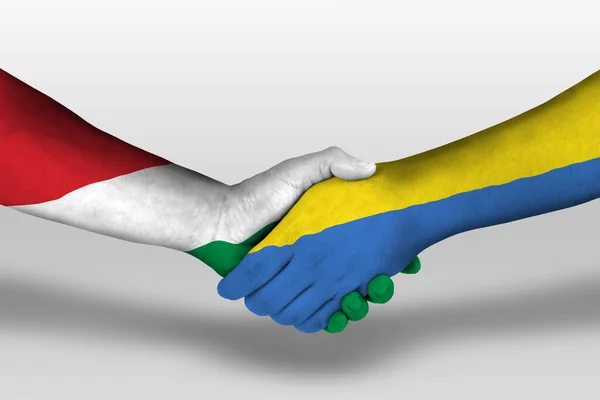 Handshake between ukraine and hungary flags painted on hands, illustration with clipping path.
