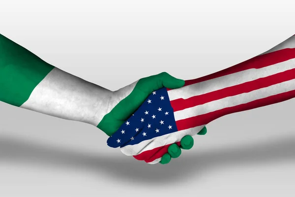 Handshake between united states of america and nigeria flags painted on hands, illustration with clipping path.
