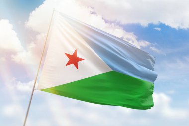 Sunny blue sky and a flagpole with the flag of djibouti