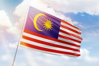 Güneşli mavi gökyüzü ve Malezya bayrağıyla bayrak direği