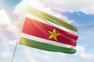 Güneşli mavi gökyüzü ve surinam bayrağıyla bayrak direği