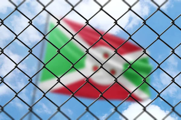 A steel mesh against the background of a blue sky and a flagpole with the flag of burundi