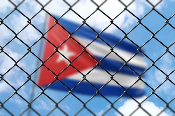 A steel mesh against the background of a blue sky and a flagpole with the flag of cuba