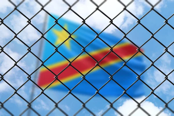 A steel mesh against the background of a blue sky and a flagpole with the flag of dr congo