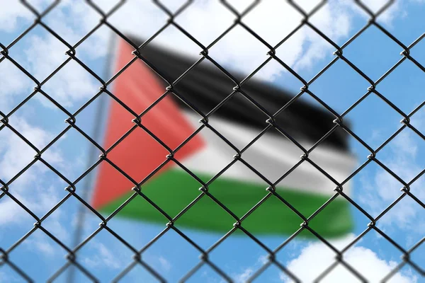 A steel mesh against the background of a blue sky and a flagpole with the flag of palestine
