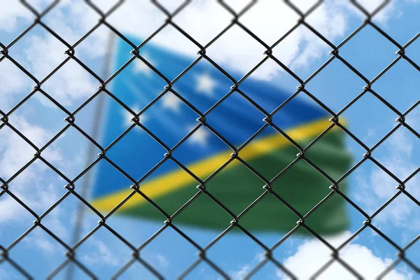 A steel mesh against the background of a blue sky and a flagpole with the flag of solomon islands