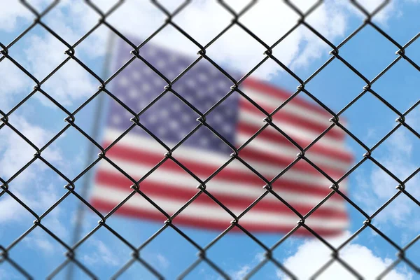 A steel mesh against the background of a blue sky and a flagpole with the flag of usa