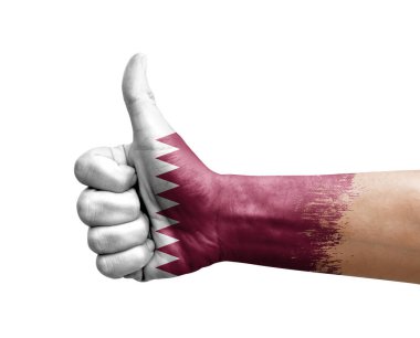 Hand making thumb up painted with flag of qatar