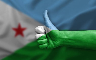 Hand making thumb up painted with flag of djibouti