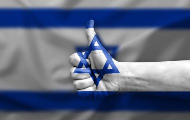 Hand making thumb up painted with flag of israel