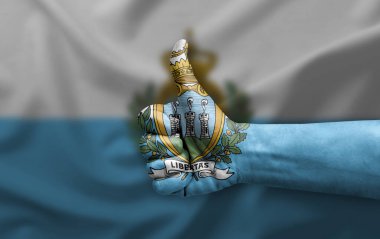 Hand making thumb up painted with flag of san marino