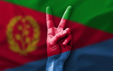 Hand making the V victory sign with flag of eritrea