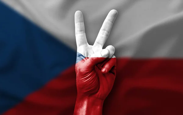 Hand making the V victory sign with flag of czechia