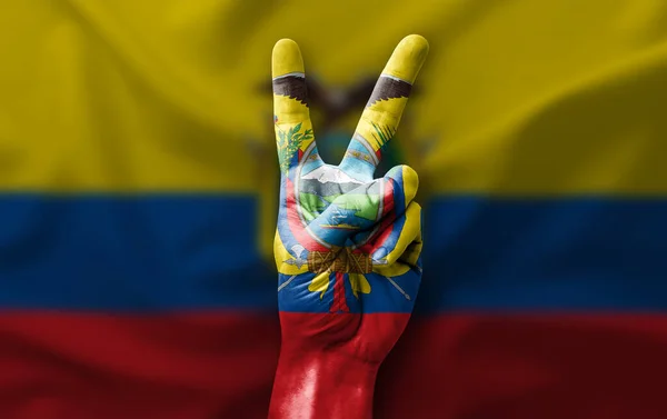 Hand making the V victory sign with flag of ecuador