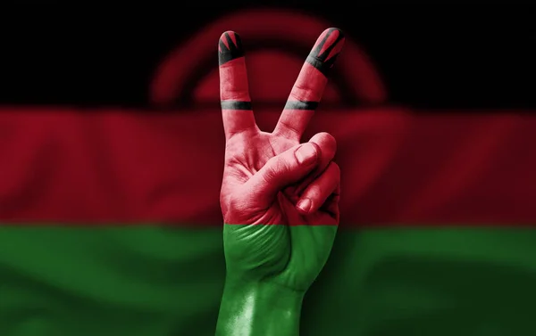 Hand making the V victory sign with flag of malawi