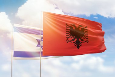 Sunny blue sky and flags of albania and israel