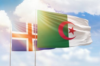 Sunny blue sky and flags of algeria and iceland