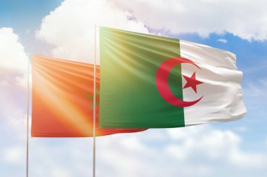 Sunny blue sky and flags of algeria and morocco