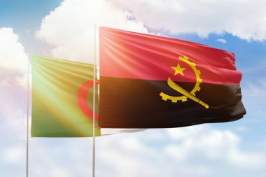 Sunny blue sky and flags of angola and algeria