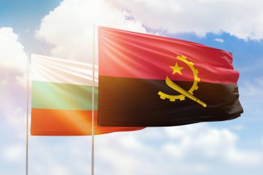 Sunny blue sky and flags of angola and bulgaria