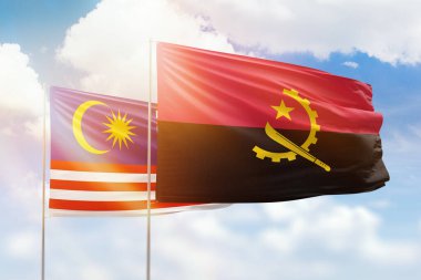 Sunny blue sky and flags of angola and malaysia