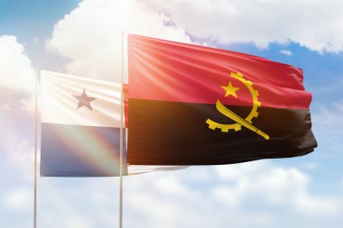Sunny blue sky and flags of angola and panama