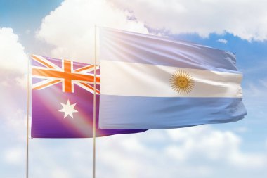 Sunny blue sky and flags of argentina and australia