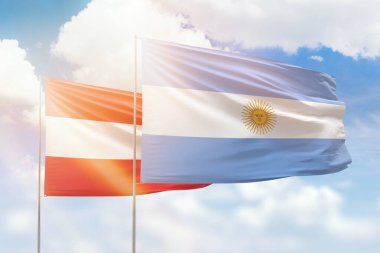 Sunny blue sky and flags of argentina and austria